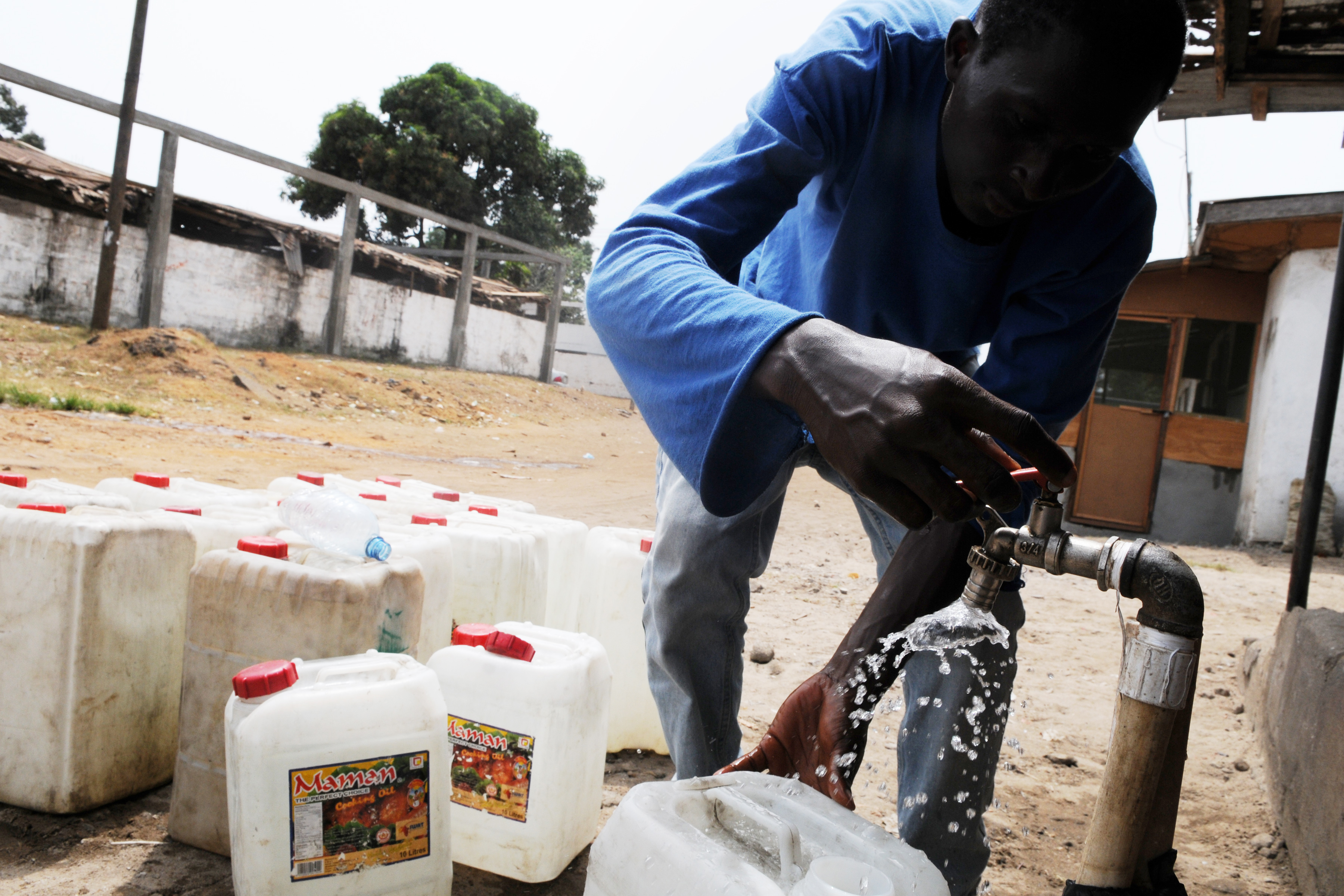 Collecting water tap in Liberia. UN Photo/Emmanuel Tobey