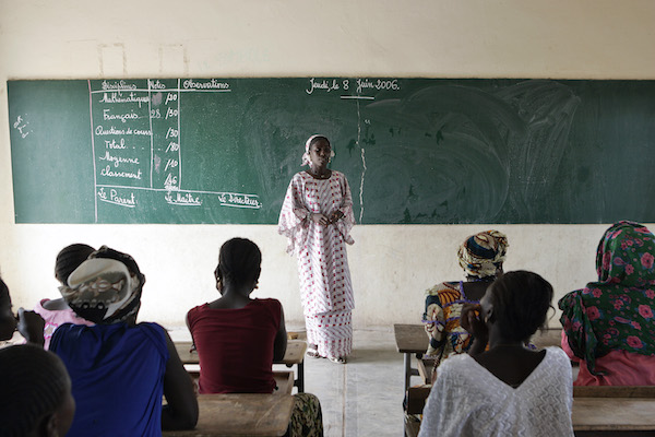 Rural women in Senegal attend a literacy class after the introduction of the Multifunctional Platform Project (MFP) by the United Nations Development Programme (UNDP), because they no longer need to spend several hours a day gathering firewood or collecting water. UN Photo/Evan Schneider