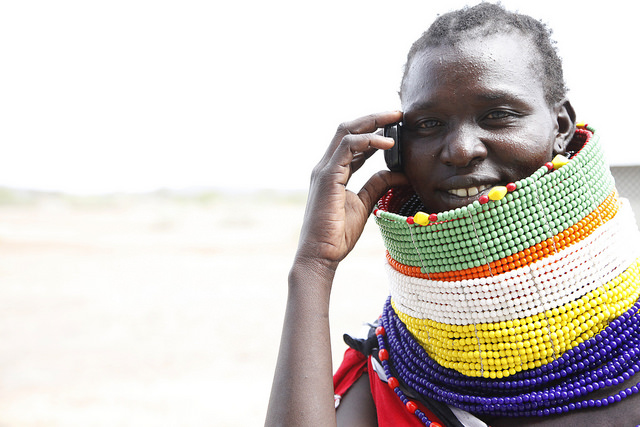 Turkana woman uses her mobile photo to communicate in Kalobeyei town, one of Kenya's integrated settlements that uses planned urbanization. Photo: Julius Mwelu/UN-Habitat