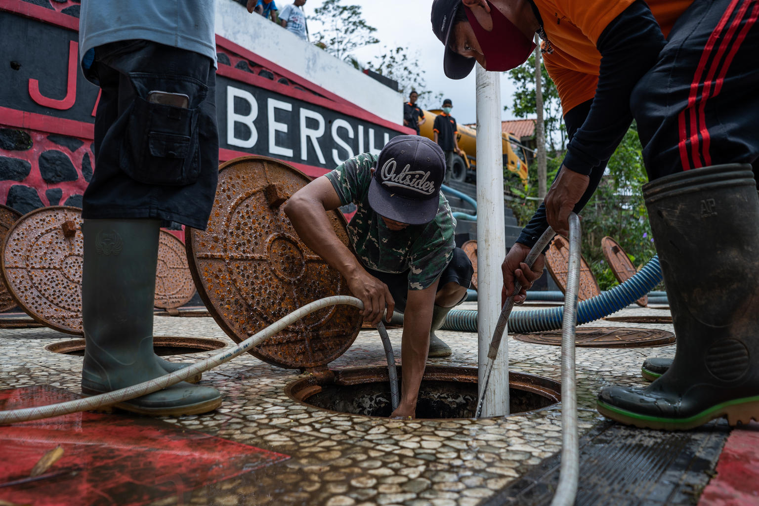 Waste management workers maintain the community sewerage system in Candimulyo village, Central Java province, Indonesia. Most houses in Candimulyo village are connected to the community sewage system, which built through a state funded sanitation programme implemented by the Ministry of Public Works and Housing. The sewage system is connected to houses using pipes and equipped with public spaces that can be utilized for community activities or gatherings. The communal sanitation system is managed by KSM Ja Billions have no access to WASH.